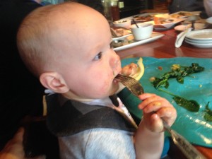 11 months: Using a fork to eat sautéed spinach while out to eat